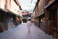 Young Asian Lady in Kimono walking in an empty Street in Higahiyama District, Gion, Kyoto, Japan Royalty Free Stock Photo