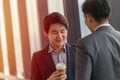 Young Asian leader businessman professional look talking together