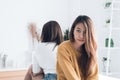 Young Asian lesbian couple argue and turn their back to each other in the period of sad in the bedroom. Royalty Free Stock Photo