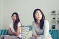 Young Asian lesbian couple argue and turn their back to each other in the period of sad in the bedroom. Royalty Free Stock Photo