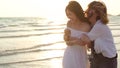 Young Asian lesbian couple running on beach. Beautiful women friends happy relax having fun on beach near sea when sunset in Royalty Free Stock Photo