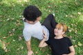 Young Asian love couple relax after an excercise in the park by playing to each other with emotion of love in warm afternoon. Royalty Free Stock Photo