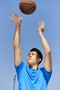 Young asian basketball player making jump shot Royalty Free Stock Photo