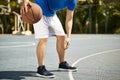 Young asian male basketball player practicing dribbling