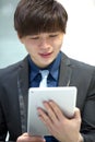 Young Asian male business executive using tablet PC Royalty Free Stock Photo