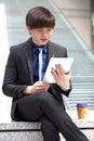 Young Asian male business executive using tablet PC Royalty Free Stock Photo