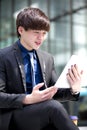 Young Asian male business executive using tablet PC Royalty Free Stock Photo