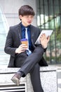 Young Asian male business executive using tablet PC Royalty Free Stock Photo