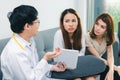 Young Asian male doctor consulting patient in hospital office. Health care and medical concept Royalty Free Stock Photo