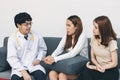 Young Asian male doctor consulting patient in hospital office. Health care and medical concept Royalty Free Stock Photo