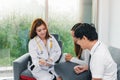 Young Asian male doctor consulting patient in hospital office. Infertility problem with marriage couple concept Royalty Free Stock Photo
