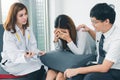 Young Asian male doctor consulting patient in hospital office. Infertility problem with marriage couple concept Royalty Free Stock Photo