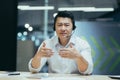 A young Asian male doctor sits in the office in a headset, online consultation of a patient Royalty Free Stock Photo