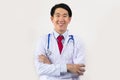 Young Asian male doctor smiling with arms folded having stethoscope on his neck isolated on white background. Royalty Free Stock Photo