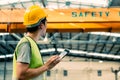 Young Asian male factory worker using a digital tablet