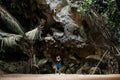 Young asian male photographer with casual cloth in forest cave t Royalty Free Stock Photo