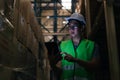 Young Asian male warehouse worker using a digital tablet inside warehouse Royalty Free Stock Photo