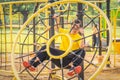 Man with autistic or down syndrome playing at playground in park