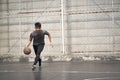 Young asian man basketball player attempting a dunk outdoors Royalty Free Stock Photo