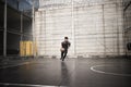 Young asian man basketball player attempting a dunk outdoors Royalty Free Stock Photo