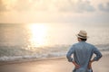 Young Asian man on the beach looking beautiful sunset Royalty Free Stock Photo