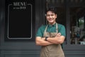 Young Asian man cafe owner entrepreneur smiling in coffee shop, small business concept Royalty Free Stock Photo