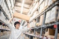 Young Asian man carry paper box over head in warehouse Royalty Free Stock Photo
