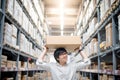 Young Asian man carry paper box over head in warehouse Royalty Free Stock Photo