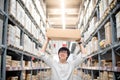 Young Asian man carry paper box over head in warehouse Royalty Free Stock Photo