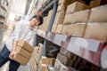 Young Asian man carrying paper boxes in warehouse Royalty Free Stock Photo