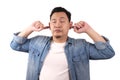 Young Asian man closing his ears dont want or avoiding to hear bad news, stress under mental pressure