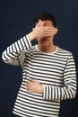 Young Asian man covering his face by palm Royalty Free Stock Photo