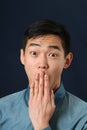 Young Asian man covering his mouth with palm Royalty Free Stock Photo