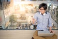 Young Asian man using smartphone and laptop Royalty Free Stock Photo