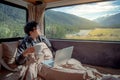 Young Asian man drinking coffee working with laptop in camper va Royalty Free Stock Photo