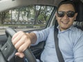 Young Asian Man Driving a Car Royalty Free Stock Photo