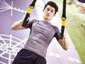 Young asian adult working out in gym Royalty Free Stock Photo