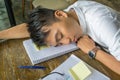 Young Asian man falling asleep on document Royalty Free Stock Photo