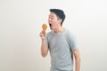 Young Asian man with fried chicken on hand Royalty Free Stock Photo