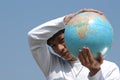 Young Asian Man with a Globe Royalty Free Stock Photo