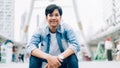 Young Asian man of happy smiling and sitting in office building.