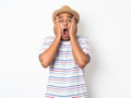 Young Asian man with hat feels shock and surprise with overly face expression. Royalty Free Stock Photo