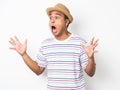 Young asian man with hat feels shock and surprise with overly face expression and looking on blank space. Royalty Free Stock Photo