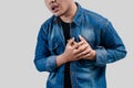 Young Asian man having chest pain or heart trouble and pressing his chest Royalty Free Stock Photo