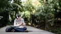 Young Asian man listening to music in the park Royalty Free Stock Photo