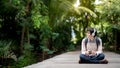 Young Asian man listening to music in the park Royalty Free Stock Photo