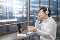 Young Asian man listening to music in workspace Royalty Free Stock Photo