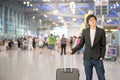 Young asian man with luggage in airport terminal Royalty Free Stock Photo