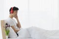 Asian man wearing red headphone, listening music Royalty Free Stock Photo