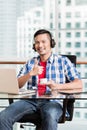 Young asian man in office having coffee giving thumbs up sign Royalty Free Stock Photo